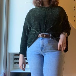 This is a green sweater with big sleeves
